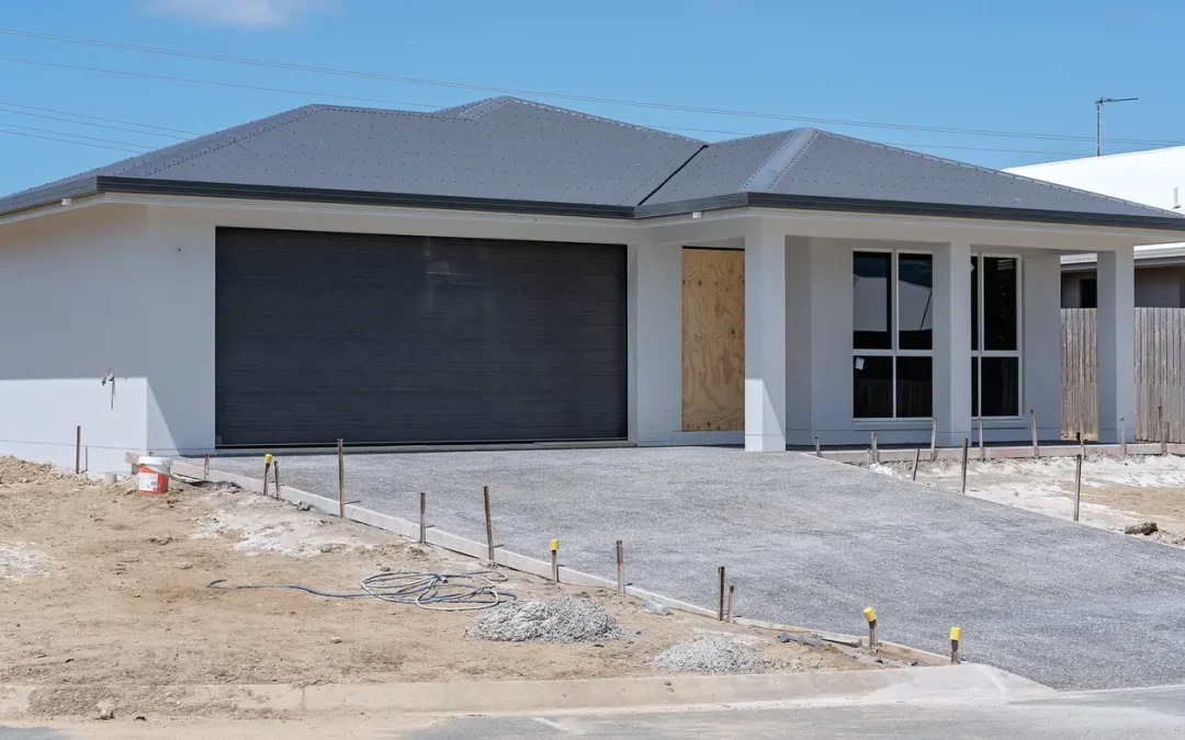Newly built Australian home nearing completion with driveway formwork, illustrating new build investment considerations